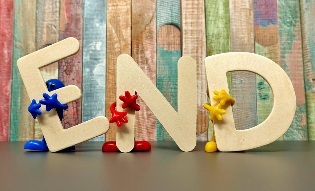 Wooden Letters "end" held up by plastic characters