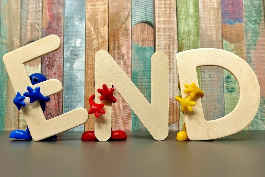 End with plastic characters holding up wooden letters