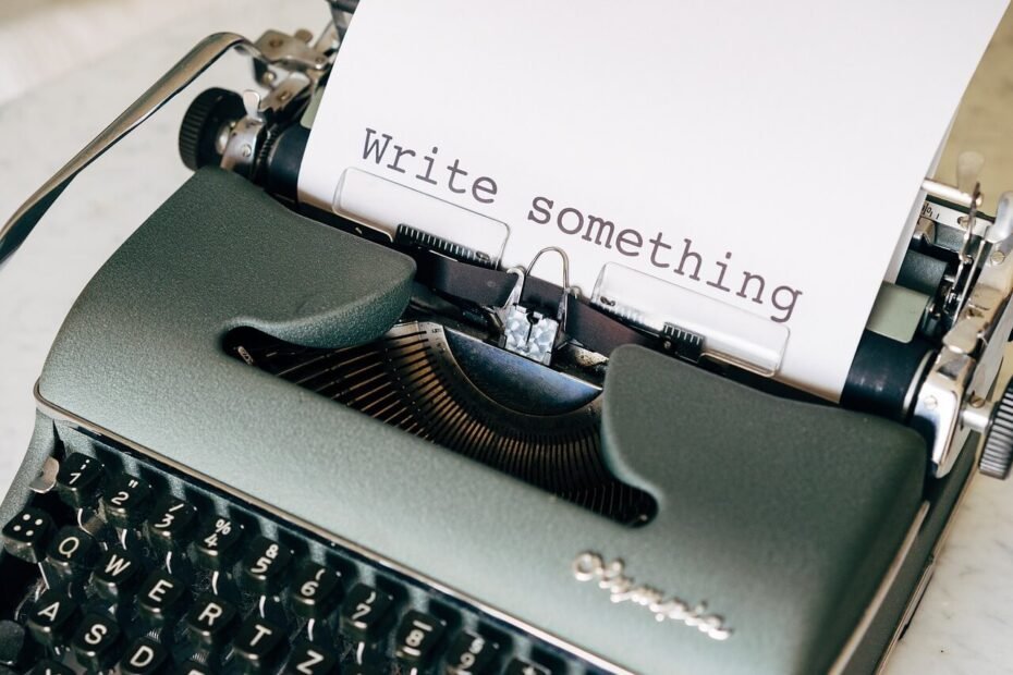typewriter with "write something" on paper